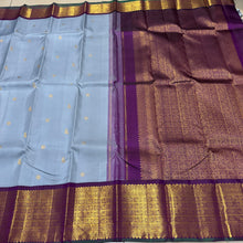 Vaibhogam- Mesmerizing Powder Greyish Blue with Deep Purple Handwoven Pure 2g Jari Korvai with Bird Buttas Woven Kanjivaram Silk with rich varisaipet borders with green selvedges gorgeous pallu and contrast woven blouse