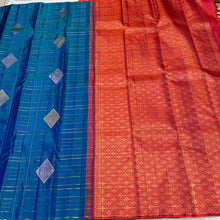 Gorgeous Mayilkazhuthu Blue with Dual tone Orange Pink Borderless Handwoven Pure Jari Kanjivaram Silk with Rich Meenakari Motifs woven Jari checked body with gorgeous Pallu and contrast woven blouse