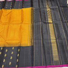 Gorgeous Mustard with Black Podikattam Checked Body with Beautiful Paisleys and small temples woven double side borders with dark Magenta Selvedges with Rich Seepu Seer Pallu and Contrast woven blouse