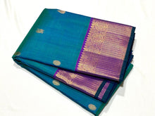 Sahana- Gorgeous Peacock Bluish Green with Purple Handwoven Pure 2g Jari Kanjivaram Silk with beautiful tear drops buttas woven body with rich mayilkan and tambalam buttas woven borders rich pallu and contrast woven blouse