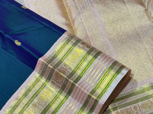 Deep Prussian Blue (dual tone of sapphire blue and green) with Soft Pink Buttas Handwoven Pure Jari Korvai Kanjivaram Silk Saree with rich meenakari varisaipet borders with vel, annam, manga, Neli streaks woven rich borders rich pallu and contrast woven