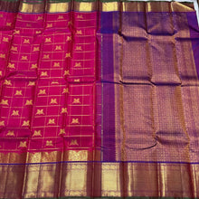 Dual tone Rani Pink with Purple in a rich Handwoven Pure Kanjivaram Silk Saree with Doubleparrots woven in jari checked body beautiful borders pallu and contrast woven blouse