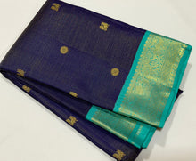 Vaibhogam- Gorgeous Navy Blue with Teal Handwoven Pure 2g Jari Korvai Kanjivaram Silk with Vairaoosi body with mayil chakram motifs woven body with beautiful borders rich pallu and contrast Vairaoosi woven blouse In teal