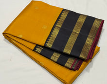 Vaibhogam- Stunning Yellow with Black Handwoven Pure 2g Jari Korvai with Buttas Kanjivaram Silk with beautiful triplepet borders with maroonish red selvedges rich pallu and a beautiful contrast black blouse