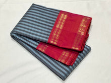 Gorgeous Handwoven Pure Jari Korvai Kanjivaram Silk Saree with greyish blue and dark grey striped body with gorgeous dual tone kanakambaram orange pink rettapet rudrakshas woven borders rich temple rekku pallu and contrast woven blouse