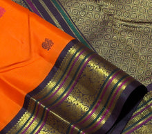 Vaibhogam- Mesmerizing Orange with Deep Coffee Brown Pure2g Jari handwoven Kanjivaram Silk with beautiful pattu buttas woven body with beautiful meenakari work woven rich borders and pallu and contrast woven beautiful blouse