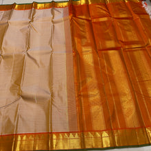 Sahana- Gorgeous Beige with Rustic Orange Handwoven Pure Jari Kanjivaram Silk with Muthukattam checks woven body with beautiful borders with green selvedges rich seer pallu and contrast woven blouse