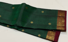 Vaibhogam- Gorgeous Bottle Green with Deep Maroon Handwoven Pure 2g Jari Korvai with Buttas Kanjivaram Silk with Self striped body with beautiful small borders rich pallu and contrast woven maroon blouse