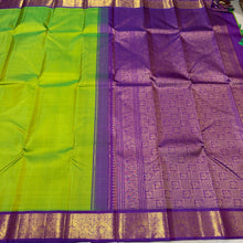 Sarasangi- Gorgeous Parrot Green with Violetish Purple Handwoven Pure 2g Jari Korvai Kanjivaram Silk with beautiful double peacocks woven borders rich pallu and contrast woven blouse