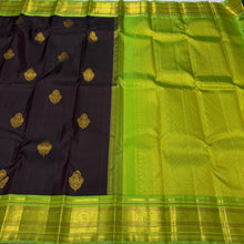 Vaibhogam- Gorgeous Deep Blackish Kanchana Brown with Parrot Green Handwoven Pure Jari Korvai with Buttas Kanjivaram Silk with beautiful double peacock motifs woven in a clover shaped motif with rich borders pallu and contrast woven blouse