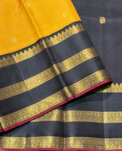Vaibhogam- Stunning Yellow with Black Handwoven Pure 2g Jari Korvai with Buttas Kanjivaram Silk with beautiful triplepet borders with maroonish red selvedges rich pallu and a beautiful contrast black blouse