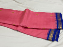 Sarasangi- Gorgeous Peachish Pink with Blue Handwoven Pure Jari Korvai Kanjivaram Silk with Oru kunjam Pillayar moggu with body buttas woven rich meena buttas woven pallu and contrast woven blouse