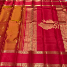 Sahana- Gorgeous Double tone Golden Mustard Shot color body with red combo in a beautiful handwoven pure Kanjivaram Silk with thilagam buttas woven with beautiful rettapet borders gorgeous simhayazhi motif woven pallu with a contrast woven red blouse