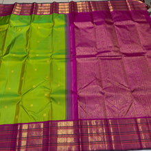 Vaibhogam- Stunning Parrot Green with Fuchsia Pink Handwoven Pure Jari Korvai Kanjivaram Silk with beautiful buttas woven body with rich varisaipet borders beautiful pallu and contrast woven blouse with bottle green selvedges