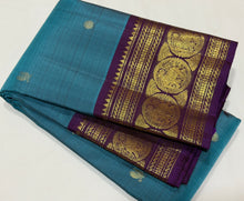 Sahana- Beautiful Teal Blue with Aubergine Purple Handwoven Pure 2g Jari Kanjivaram Silk with beautiful buttas woven body with rich elephants woven borders gorgeous pallu and contrast woven blouse
