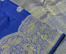 Vaibhogam- Stunning Royal Blue with Gold Handwoven Pure 2g Jari Kanjivaram Silk with beautiful peacocks and iruthalaipakshi motits woven body with beautiful turning borders with gorgeous weaving rich pallu and buttas woven blouse