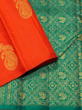 Saranga- Stunning Orange with Emerald Green Muthukattam with Peacock on a paisley motifs woven beautiful body rich and finely woven pallu and contrast emerald green blouse