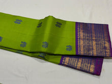 Vaibhogam- Mesmerizing Parrot Green with Violetish Purple Handwoven Pure Jari Korvai Kanjivaram Silk with Pattu buttas woven body with rich borders gorgeous pallu and contrast woven blouse