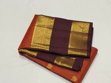 Vintage Beauty in a Rich Rust and Dark Brown Combination with Vairaoosi Jari Kattam with Mayil Chakram Buttas Doublepet borders rich pallu and contrast woven blouse