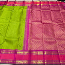 Vaibhogam -Gorgeous Parrot Green with Pink Vairaoosi Handwoven Pure Korvai Kanjivaram Silk with doublepet borders in pink and orange shades with rich pallu and contrast Vairaoosi woven beautiful blouse