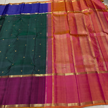 Sahana- Stunning Bottle Green with Ganga Jamuna Borders with buttas with contrast kanakambaram Orange Pallu and blouse in a beautiful Handwoven Pure 2g Jari Kanjivaram Silk Beauty