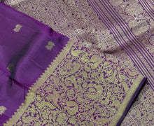 Vaibhogam- Stunning Deep Purple with Gold Handwoven Pure 2g Jari Kanjivaram Silk with beautiful yazhi and mayil buttas woven body with rich Vanasingaram borders on either sides with rich pallu and self colored blouse