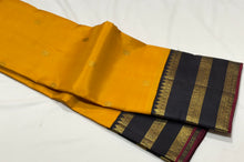 Vaibhogam- Stunning Yellow with Black Handwoven Pure 2g Jari Korvai with Buttas Kanjivaram Silk with beautiful triplepet borders with maroonish red selvedges rich pallu and a beautiful contrast black blouse