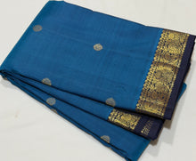 Vaibhogam- Mesmerizing Royal Azure Blue with Navy Blue Handwoven Pure 2g Jari Korvai Kanjivaram Silk with Buttas woven body with beautiful small intricate borders rich pallu and contrast navy blue blouse