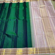 Sarasangi-Mindblowing Deep Peacock Green with Baby Pink Handwoven Pure Jari Korvai Kanjivaram Silk with gorgeous baby pink borders with paisleys woven with classic seepu seer pallu and contrast woven blouse