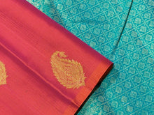 Saranga- Gorgeous Dual tone Orange With Turquoise Green Borderless Handwoven Pure Jari Kanjivaram Silk with Muthukattam woven body with beautiful paisley motifs rich 1000 buttas style woven pallu and contrast woven blouse