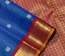 Vaibhogam- Gorgeous Peacock Blue with Deep Arakku Red  Handwoven Pure 2g Jari Korvai with Buttas Kanjivaram Silk with rich borders gorgeous pallu and contrast woven blouse