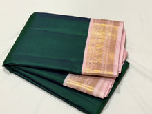Sarasangi-Mindblowing Deep Peacock Green with Baby Pink Handwoven Pure Jari Korvai Kanjivaram Silk with gorgeous baby pink borders with paisleys woven with classic seepu seer pallu and contrast woven blouse