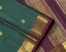 Vaibhogam- Gorgeous Bottle Green with Deep Maroon Handwoven Pure 2g Jari Korvai with Buttas Kanjivaram Silk with Self striped body with beautiful small borders rich pallu and contrast woven maroon blouse