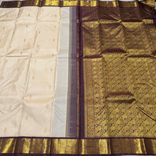 Offwhite with Coffee Brown Handwoven Pure Jari Korvai Kanjivaram Silk Saree with rich beautiful yazhis and peacocks woven borders rich pallu and contrast woven blouse