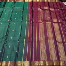 Vaibhogam- Gorgeous Bottle Green with Deep Maroon Handwoven Pure 2g Jari Korvai with Buttas Kanjivaram Silk with Self striped body with beautiful small borders rich pallu and contrast woven maroon blouse