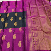 Saranga-Gorgeous Mubbakam Style Handwoven PureKanjivaram Silk in a beautiful black and deep magenta combination with middle portion in black and eithersides in deep magenta color with muthukattam striped body with paisleys woven with rich pallu and blouse