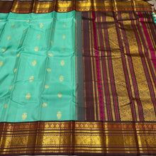 Vaibhogam- Stunning Turquoise Double tone Bluish Green Body with Deep Coffee Brown Handwoven Pure Jari Korvai Kanjivaram Silk with beautiful buttas woven body rich meenakari work woven borders and pallu and contrast woven blouse