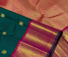 Vaibhogam- Stunning Bottle Green with Tomato Orange Pink Handwoven Pure 2gram Jari Korvai with Mayil Chakram Buttas Kanjivaram Silk with rich borders beautiful pallu and contrast woven blouse