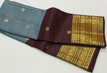 Vaibhogam-Beautiful Pastel Blue with Dark Brown Handwoven Pure Jari Korvai Kanjivaram Silk with Vairaoosi with buttas woven middle body with coffee brown buttas woven lower body and rich broad borders gorgeous pallu and contrast woven blouse