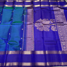 Rama  Bluish Green  with Royal Blue Handwoven Pure Kanjivaram Silk Saree with beautiful deers and peacocks motifs woven body with rettapet borders rich vanasingaram style woven pallu with elephants peacocks under a tree and contrast woven blouse.