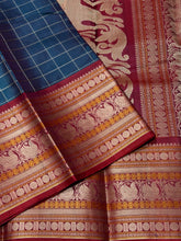 Saraswati- Gorgeous Teal Blue wkth Maroonish Red Handwoven Premium Zariless Kanjivaram Silk with beautiful muthukattam silk checked body with gorgeous varisaipet borders rich sorgavaasal pallu and contrast woven blouse