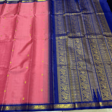 Sarasangi- Gorgeous Peachish Pink with Blue Handwoven Pure Jari Korvai Kanjivaram Silk with Oru kunjam Pillayar moggu with body buttas woven rich meena buttas woven pallu and contrast woven blouse