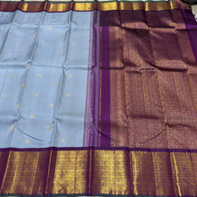 Vaibhogam- Mesmerizing Powder Greyish Blue with Deep Purple Handwoven Pure 2g Jari Korvai with Bird Buttas Woven Kanjivaram Silk with rich varisaipet borders with green selvedges gorgeous pallu and contrast woven blouse