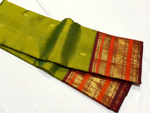 Vaibhogam- Gorgeous Olive Green with Deep Maroonish Brown Handwoven Pure Jari Korvai Kanjivaram Silk with beautiful Varisaipet borders rich pallu and contrast woven blouse