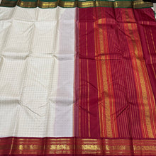 Offwhite with Arakku Red and Emerald Green Ganga Jamuna Korvai Borders with Plus buttas in silk threads woven all over the body with rich arakku pallu and simple green pallu on the other side which can be worn on either sides with a single arakku blouse