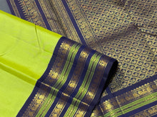 Gorgeous Pastel Green with Navy Blue Handwoven Pure Jari Korvai Plain Body Kanjivaram Silk Saree with rich Varisaipet Meenakari Borders Rich Pallu and Contrast Woven Blouse