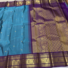 Sahana- Beautiful Teal Blue with Aubergine Purple Handwoven Pure 2g Jari Kanjivaram Silk with beautiful buttas woven body with rich elephants woven borders gorgeous pallu and contrast woven blouse