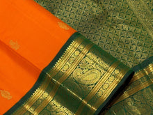 Vaibhogam- Stunning Orange with Bottle Green Handwoven Pure Zari Korvai Kanjivaram Silk with Buttas woven body with rich Borders gorgeous pallu and contrast green blouse