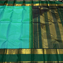 Vaibhogam- Beautiful Light Green with Dark Bottle Green Handwoven Pure Zari Korvai Kanjivaram Silk with beautiful spaced light and dark green double borders rich seer pallu and contrast woven bottle green blouse