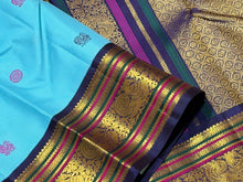 Vaibhogam- Gorgeous Powder Blue with Deep Blue Handwoven Pure Jari Korvai Kanjivaram Silk with gorgeous pattu buttas woven body rich meenakari silk thread and zari woven beautiful borders rich pallu with very intricate and contrast woven beautiful blouse